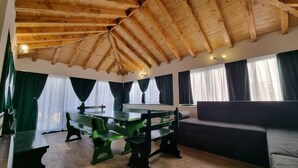 A room with a wooden ceiling, green and black furniture, and large windows with curtains. - Luxury villa complex Pendolino with heated pool and jacuzzi (Kastela)