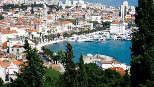 A coastal cityscape with a marina, historic buildings, and a mountainous backdrop. - Exclusive apartment in center with amazing view! (Split)