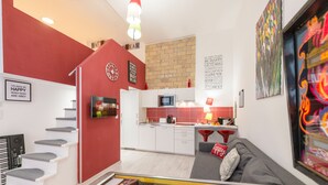 A modern apartment with a kitchen, living area, and a staircase. - happy home Budapest FOX (Budapest)