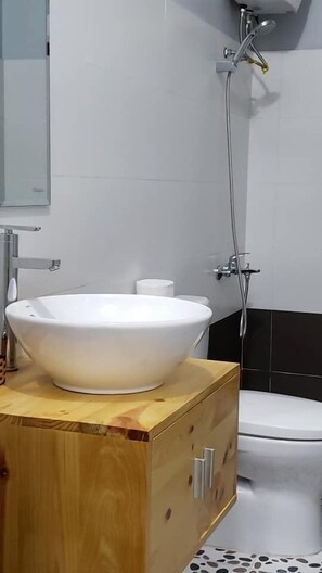 Shower, hair dryer, slippers, towels