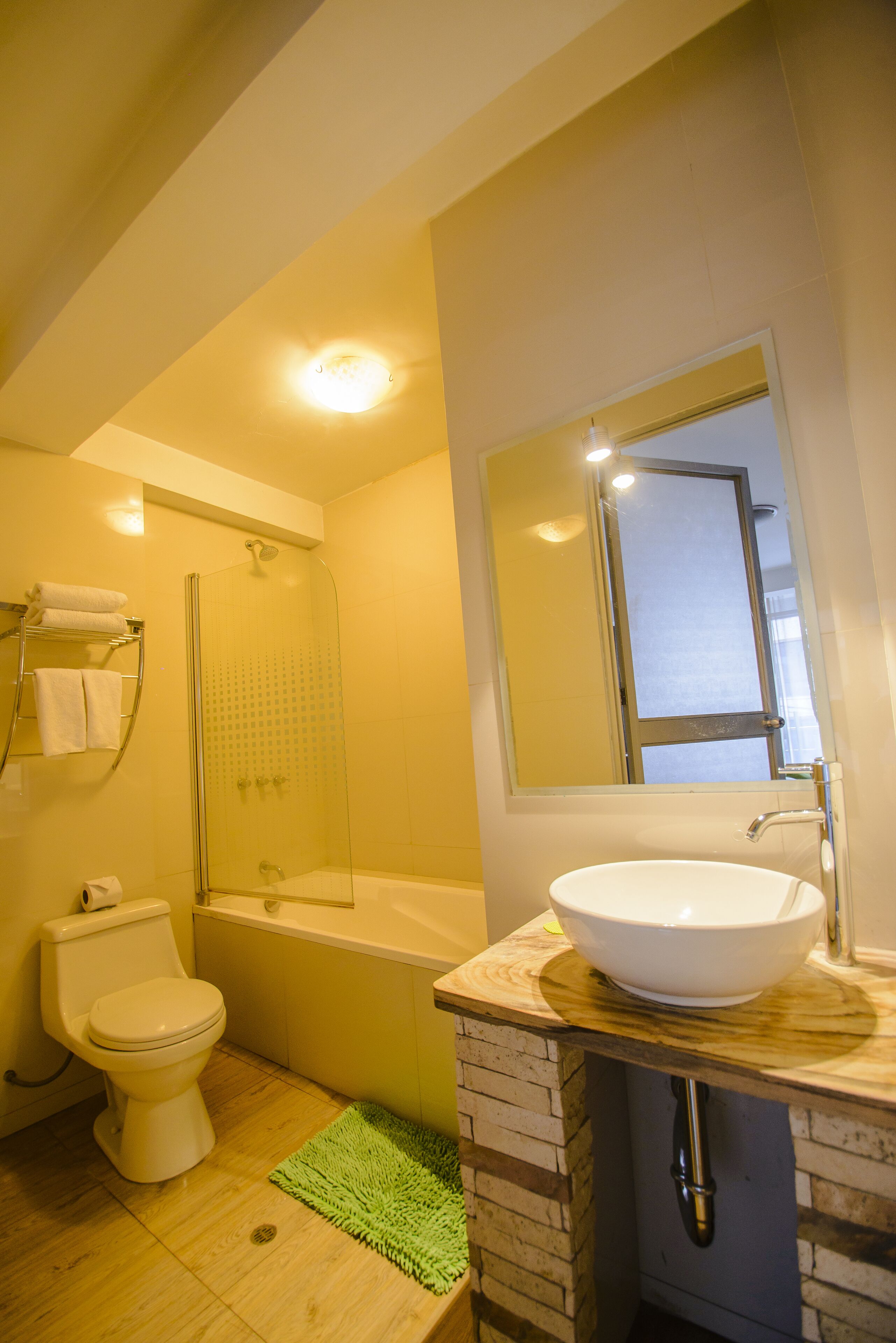 deluxe quadruple room | bathroom | combined shower/bathtub, hair dryer, towels, soap