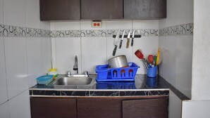 A kitchen with a sink, cabinets, and a countertop. - Sunset Terrace - Hostel (Cartagena)