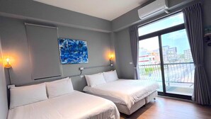 A hotel room with two beds, a large window with a view of the city, and an air conditioning unit on the wall. - SunLight Forest (Taitung)