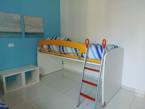 A bunk bed with a ladder, a small bench, and two paintings on the wall. - The house of olive trees (Francavilla al Mare)