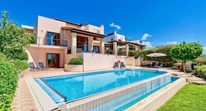 A modern two-story house with a swimming pool, outdoor seating, and a well-maintained garden. - Villa 98 Helidonis - Four Bedroom Villa, Sleeps 8 (Kouklia)
