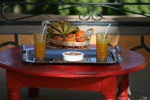 Enjoy a casual outdoor dining experience with a refreshing spread of fresh fruit and nuts.