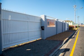 A white fence with a sign for 'Annex Lodge - SPA' and a mailbox. - Annex Lodge (Cape Town)
