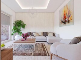 Uma sala de estar moderna com um sofá, uma mesinha de centro com flores, uma planta em vaso e um quadro na parede.