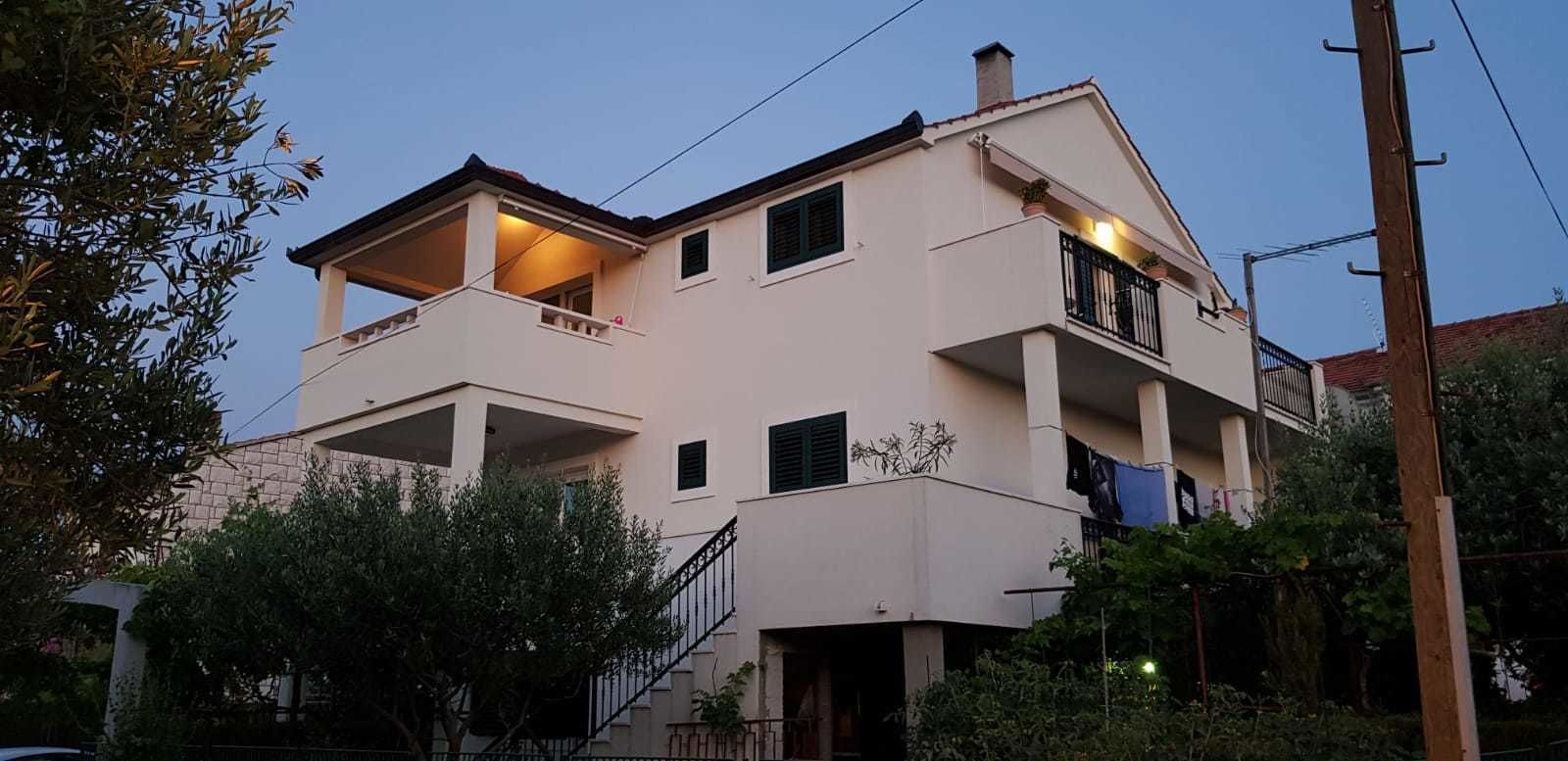 A two-story building with a balcony on the upper floor.