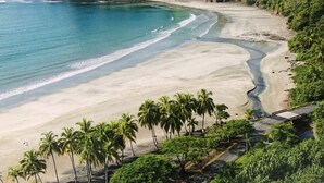 A beach with clear turquoise waters, a sandy shore, and lush greenery. - Your Dream Costa Rica Villa - Ocean View Lap Pool - Private Chef-Secret Beach (Puerto Carrillo)