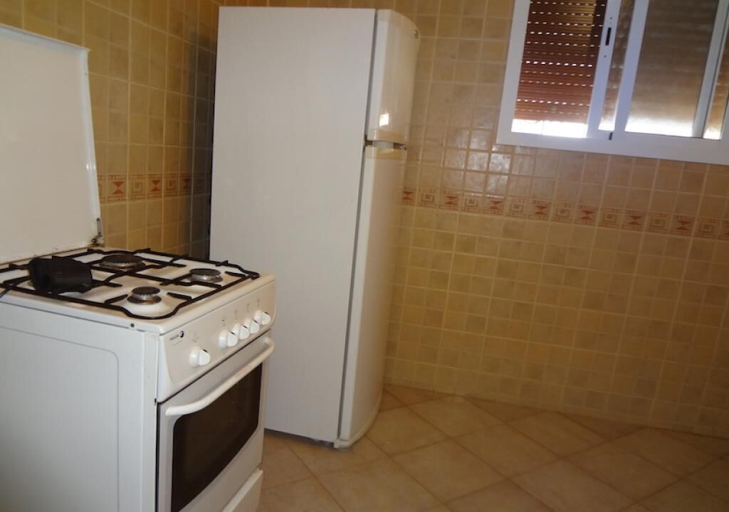 A kitchen with a stove, oven, and refrigerator.