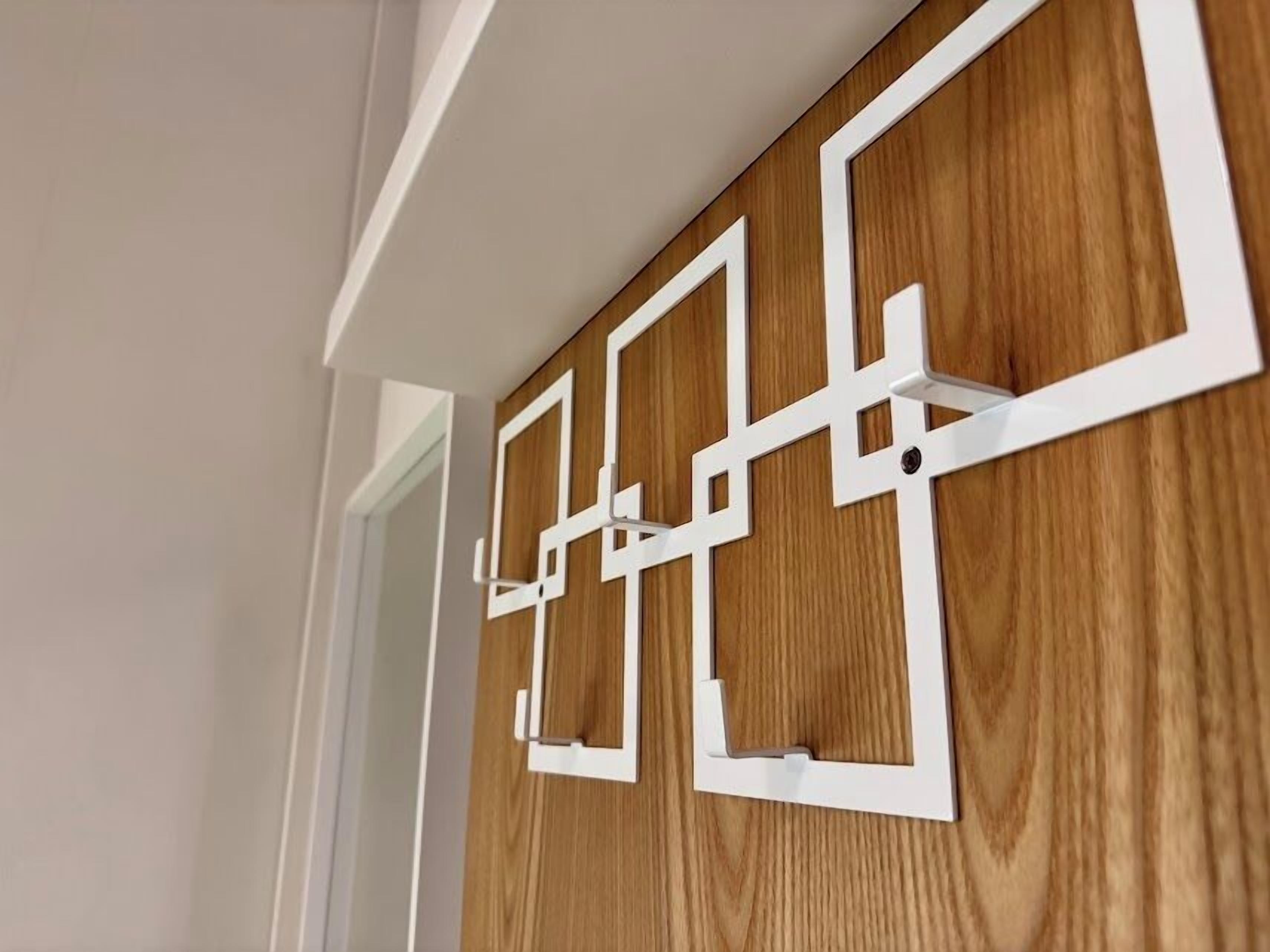A wooden wall with white geometric cutouts.