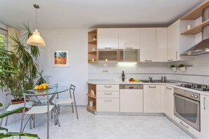 Enjoy cooking in this well-equipped kitchen with a central island, dishwasher, and ample counter space.