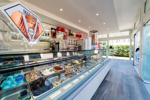 Une boutique de glaces moderne où une grande variété de parfums sont présentés dans une vitrine réfrigérée.