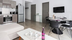 Eine moderne, gut beleuchtete Wohnung mit Küchenzeile, Essbereich und Wohnraum.