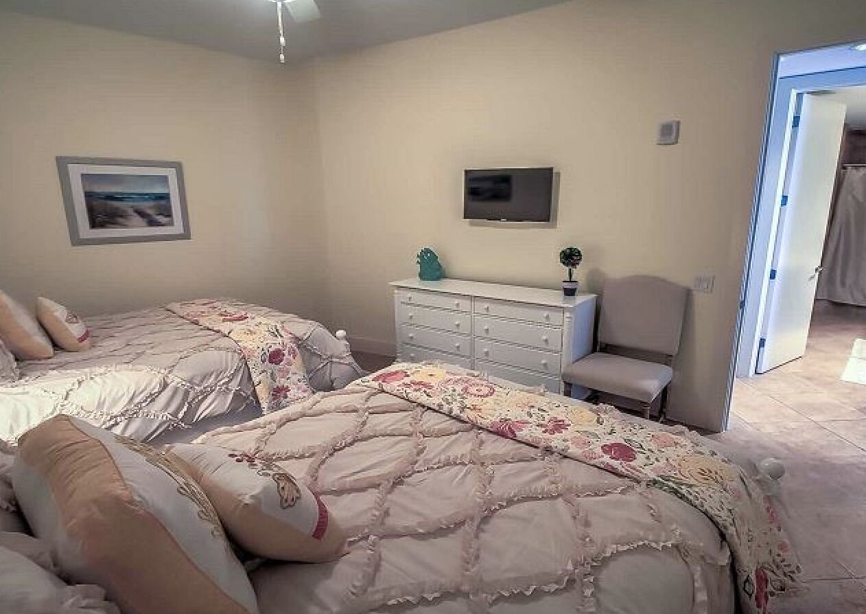 Bedroom #2 includes TV and chest of drawers.