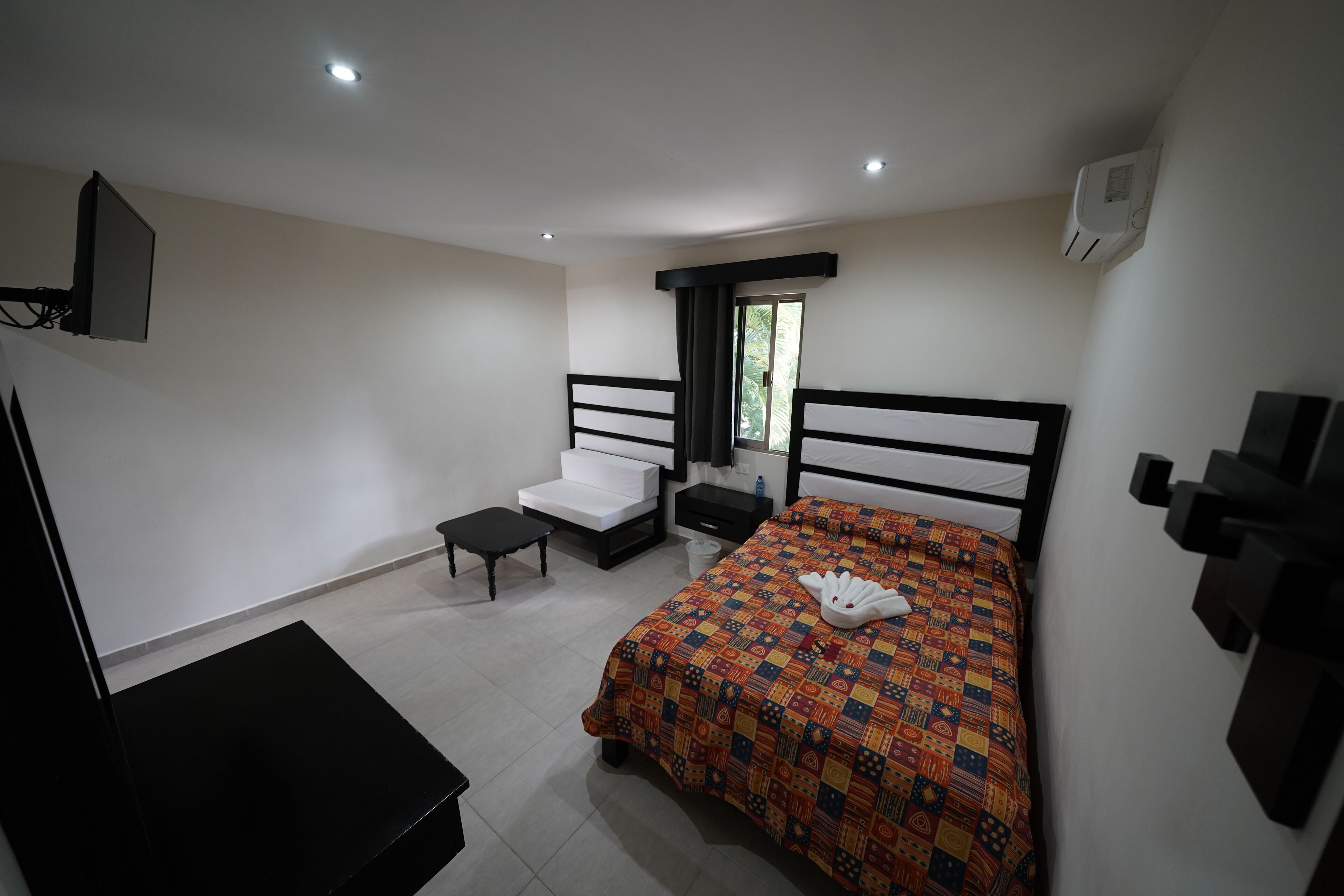 standard double room | living area | 28-inch flat-screen tv with cable channels, tv