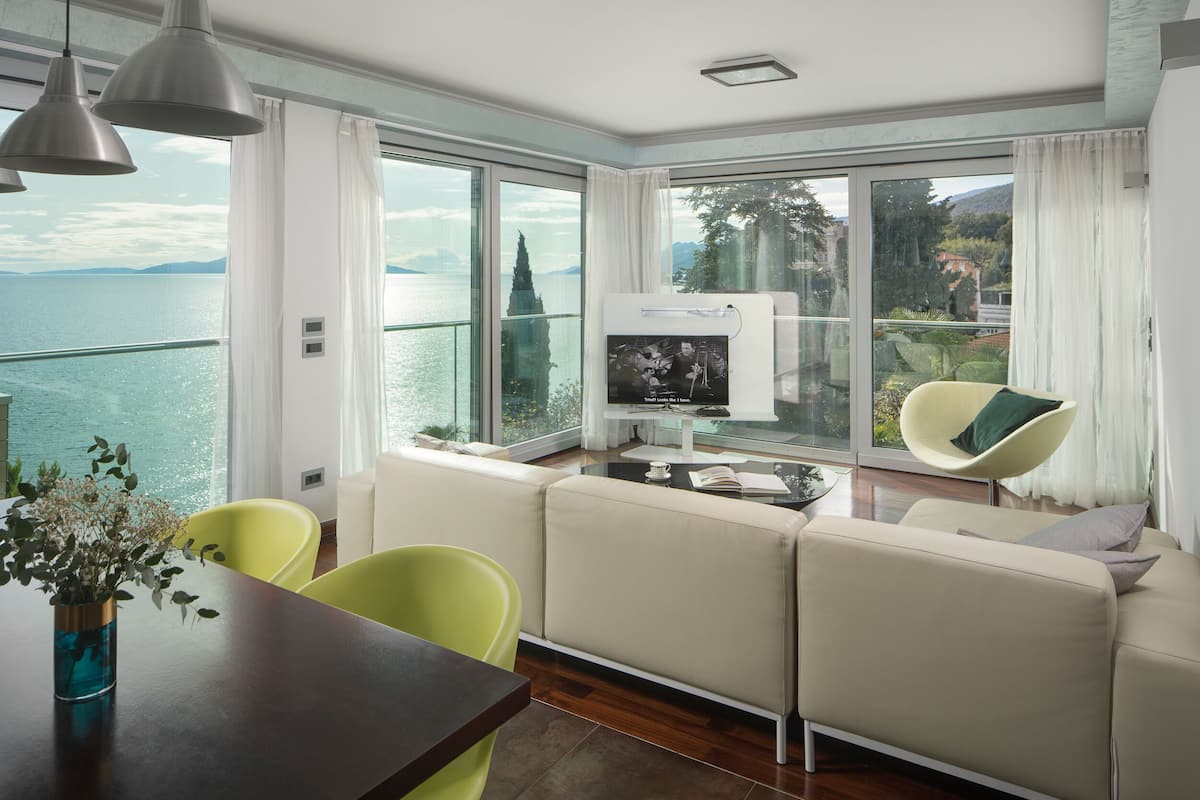 Deluxe Apartment, 2 Bedrooms, Pool View, Beachfront | Living area | Flat-screen TV, heated floors