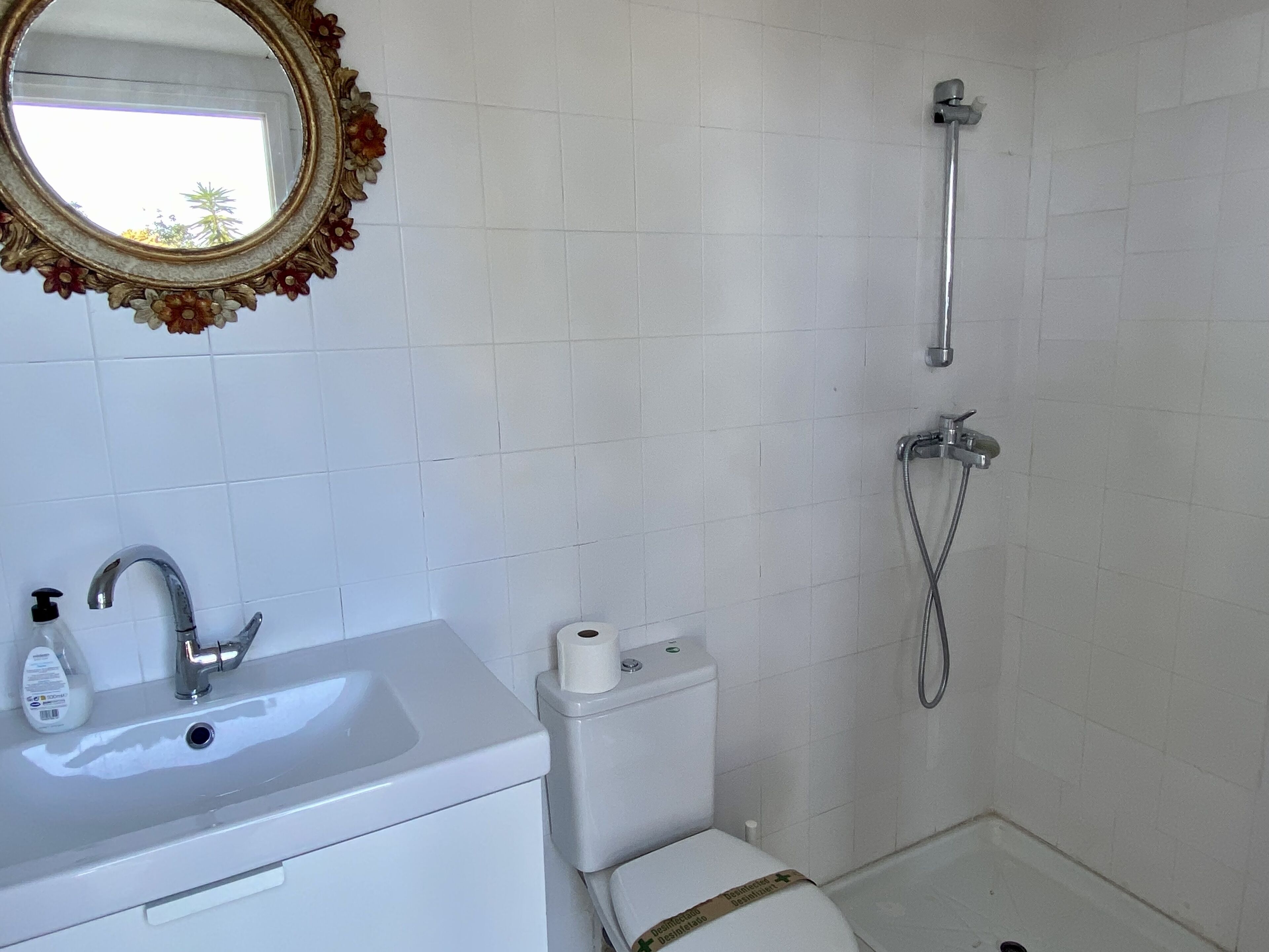 A bathroom with a sink, toilet, and shower.