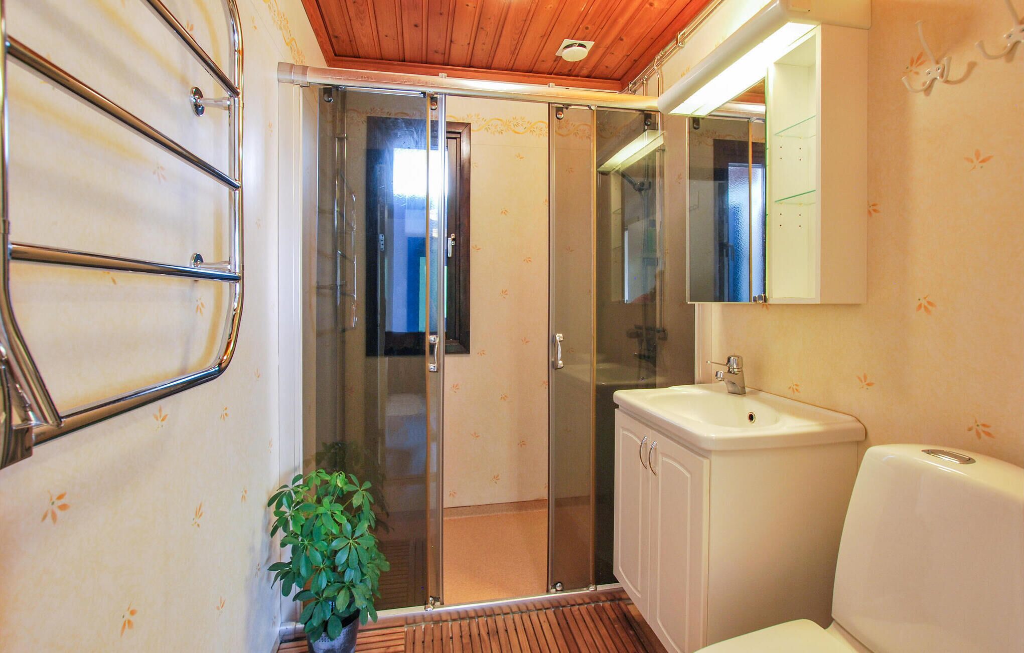 Un baño con ducha, lavabo y espejo.