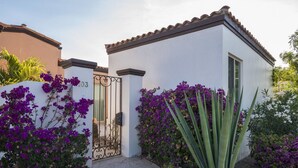 A white building with a number '103' and a metal gate. - Paraiso Del Mar Resort V103 3 Bed by Casago (La Paz)