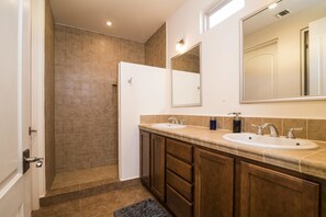 A bathroom with two sinks, a shower, and a large mirror. - Paraiso Del Mar Resort V103 3 Bed by Casago (La Paz)