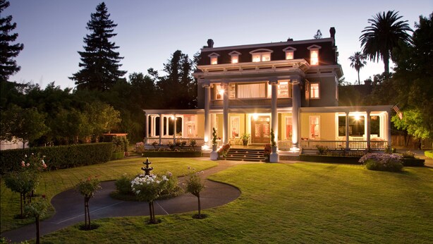 A large, two-story house with a well-maintained lawn and a fountain in the center. - Churchill Manor B&B (Napa)
