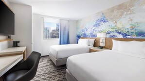 A hotel room with two beds, a desk, a chair, a TV, and a window with curtains. - Courtyard by Marriott New York Downtown Manhattan/Financial District (New York)