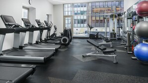 A modern gym with treadmills, weight machines, and exercise balls. - Courtyard by Marriott New York Downtown Manhattan/Financial District (New York)