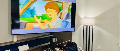 A television mounted on a wall displaying an animated scene.