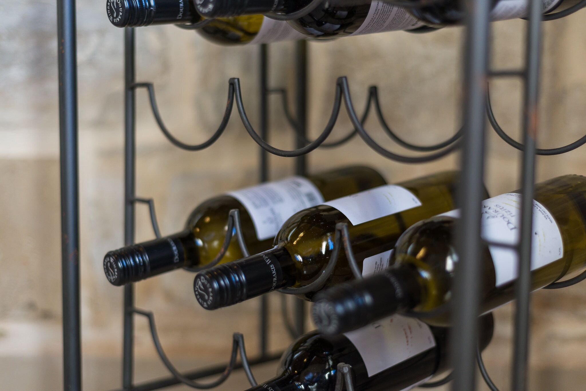 A wine rack with several bottles of wine.