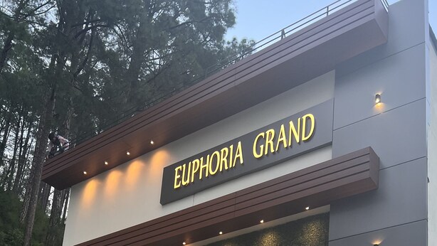 A modern building with the name "Euphoria Grand" illuminated on the facade. - The Euphoria Grand (Shimla)