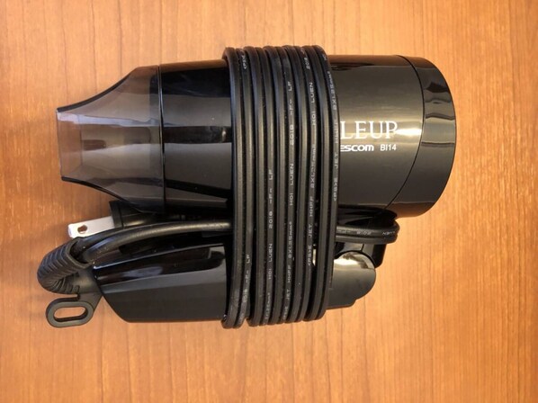 A LEUP Scom BI14 camera lens with multiple lens elements and a black strap. - DEUXQ STAY DOTONBORI HOTEL (Osaka)