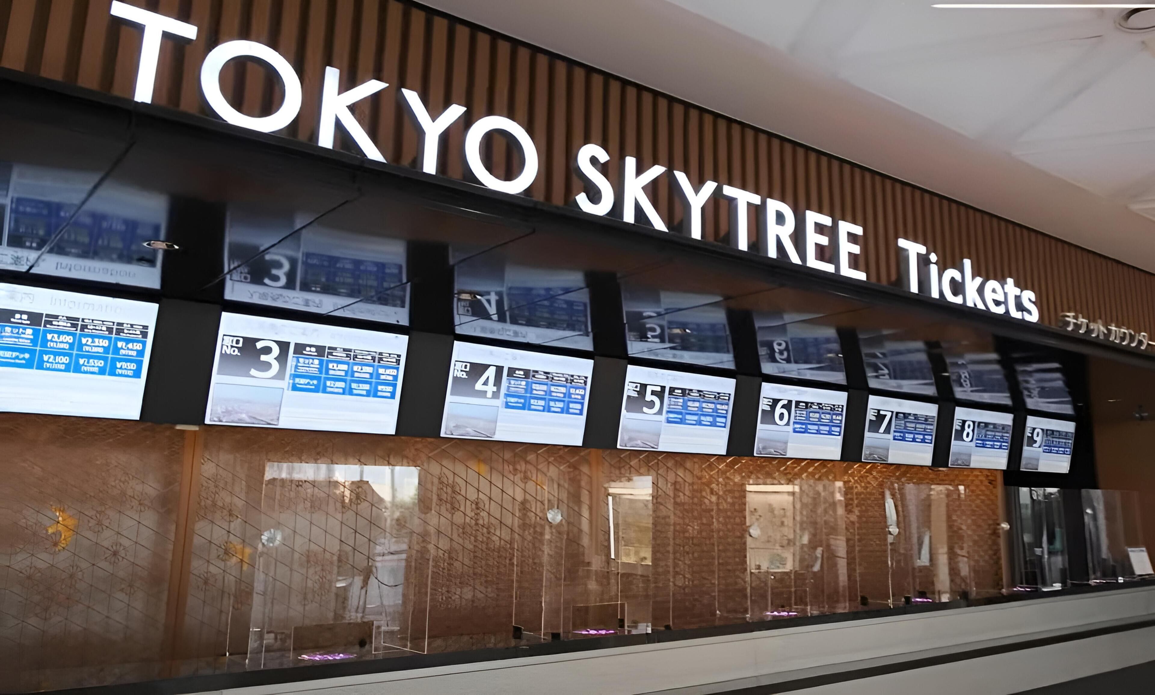 A Tokyo Skytree Ticket office with a large sign and ticket display boards.