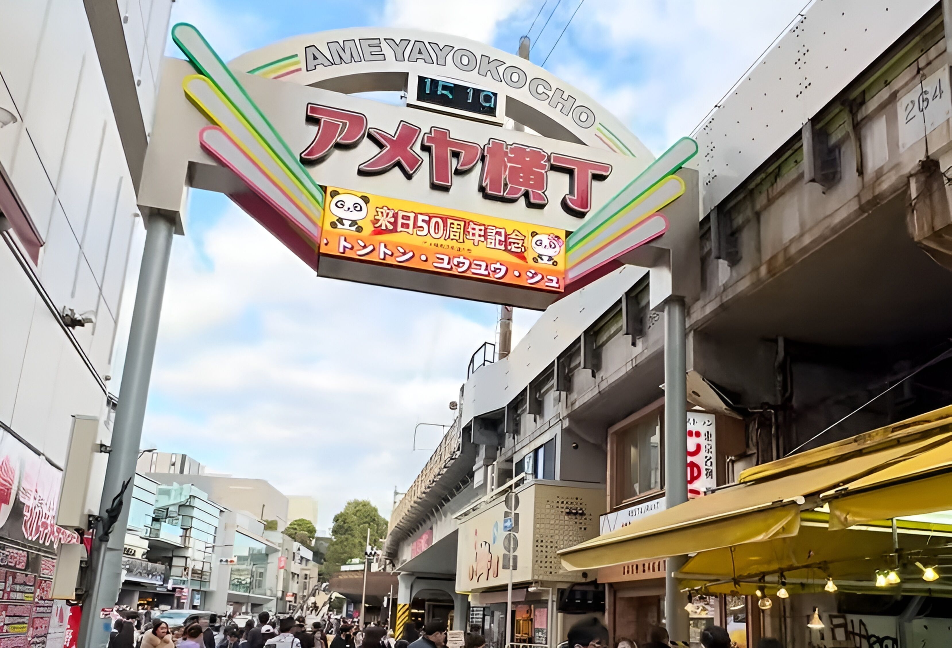 Una calle concurrida con un letrero destacado de AmeYayokoKocho.