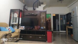 A living room with a TV, sofa, and a staircase leading to another room. - Autumn Water (Jinning)