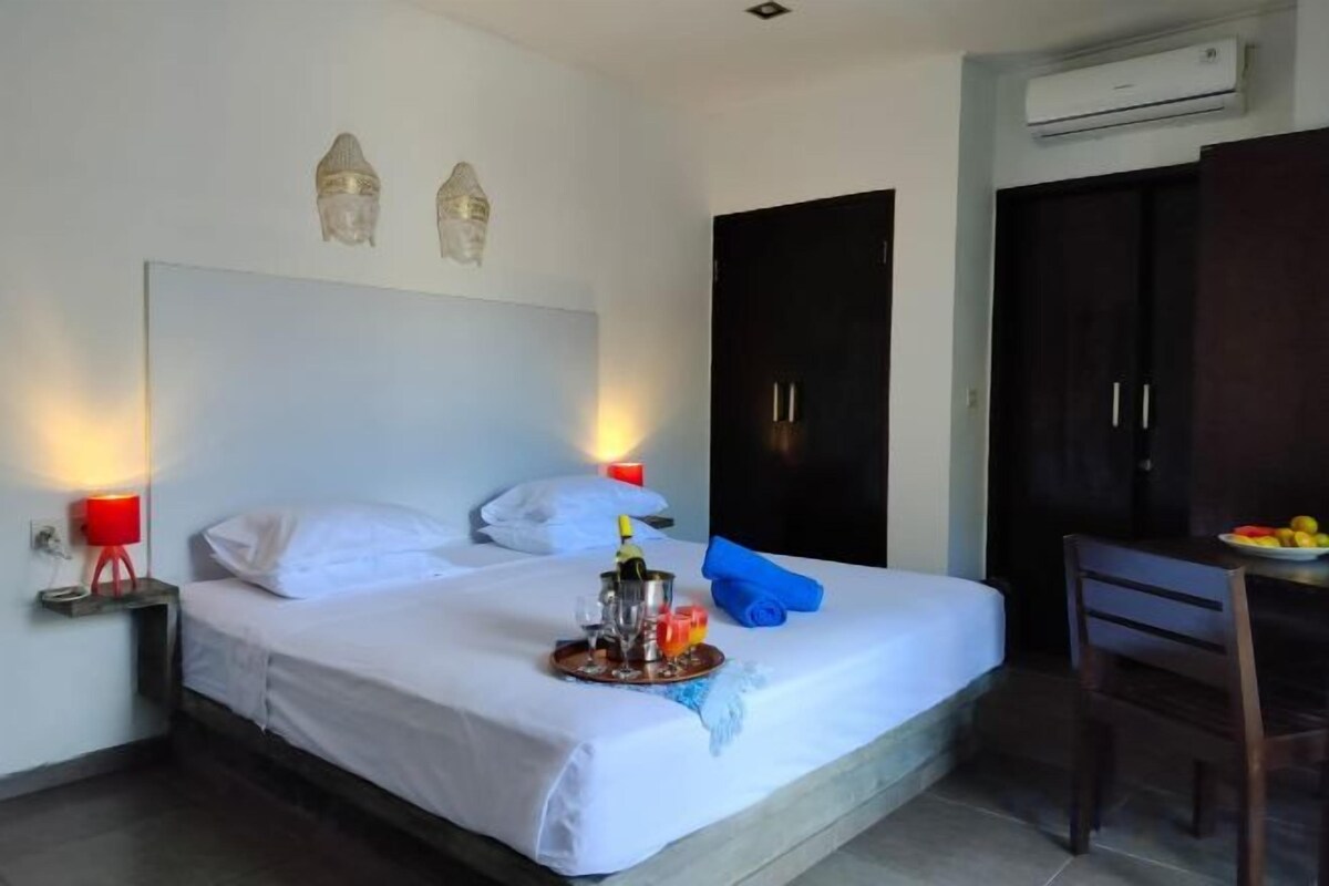 Premium bedding, Select Comfort beds, laptop workspace, blackout drapes