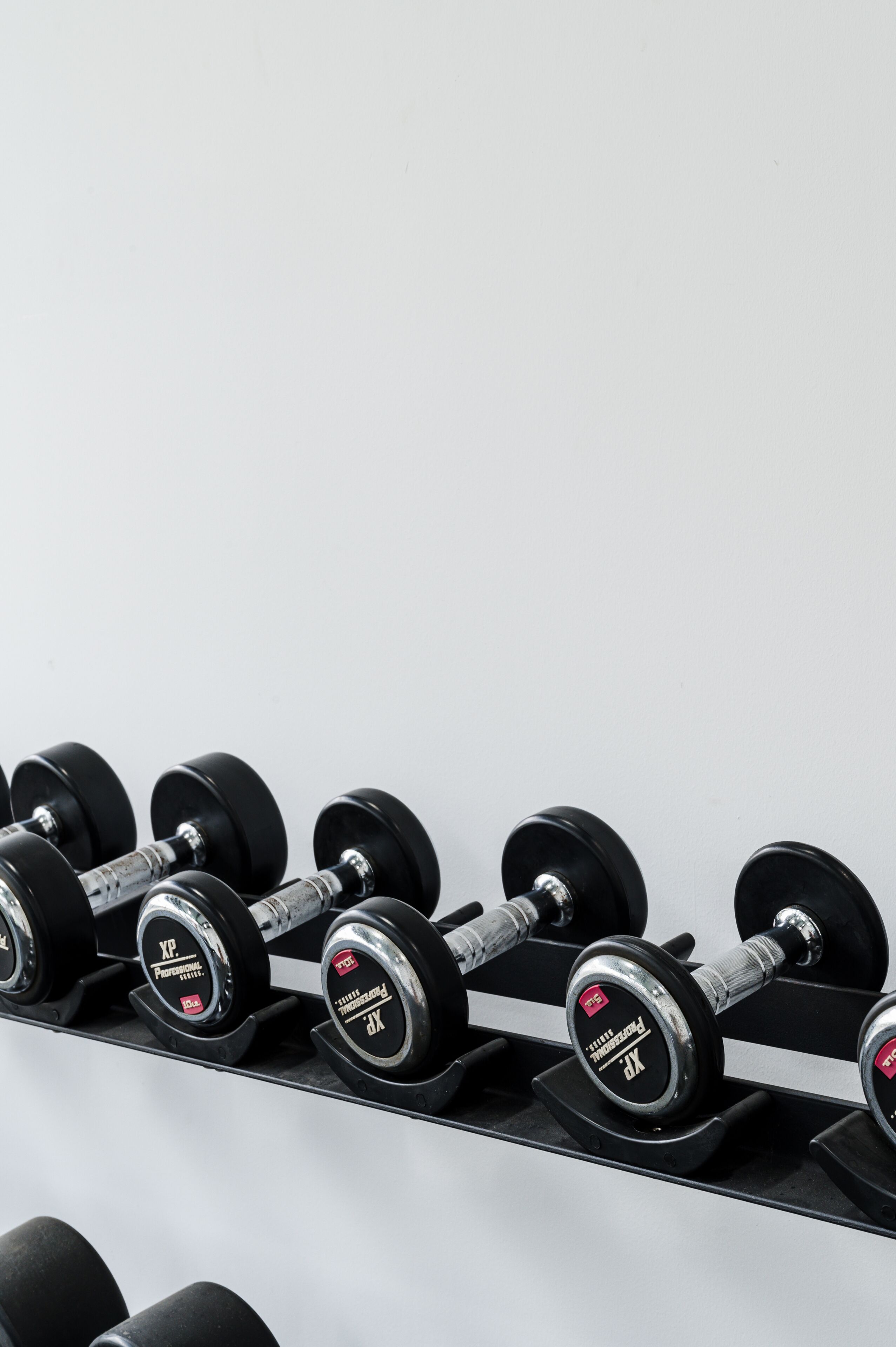 A set of dumbbells on a rack.