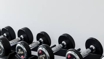 A set of dumbbells on a rack.
