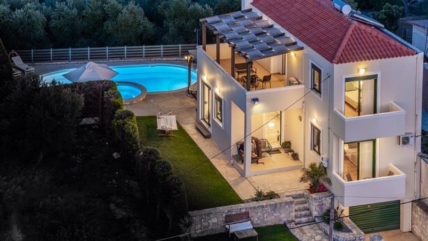 A modern two-story house with a swimming pool, outdoor seating, and a stone staircase leading to the entrance. - Holiday villa with private pool (Ξηροκάμπι)