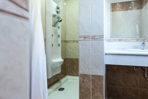Shower, hair dryer, towels, toilet paper