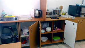 A compact kitchen with a sink, a coffee maker, a microwave, and a refrigerator. - Apartment "Grace" with 2 spaces, at the foothills of Filerimos, Ialysos - Rhodes (Ιαλυσός)