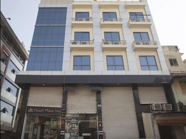 A multi-story hotel with a modern facade, featuring balconies on each floor. - Hotel Plaza Inn Ajmer (Ajmer)