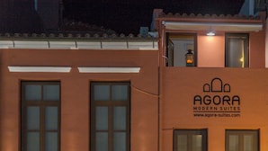 A building with a sign for "Agora Modern Suites" and a website address. - Agora Suites  - Stay in the HEART of CHANIA (Χανιά)
