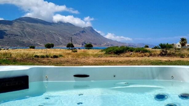A hot tub with a clear view of a mountainous landscape in the background.