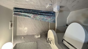 A bathroom with a marble floor, a white bathtub, and a shower area. - Home WIFI & Compact & Tranquil Apt with LOFT! (杉並区)