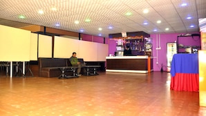 A spacious lobby with a reception desk, seating area, and a bar. - Kathmadu Fawlty Home (Kathmandu)