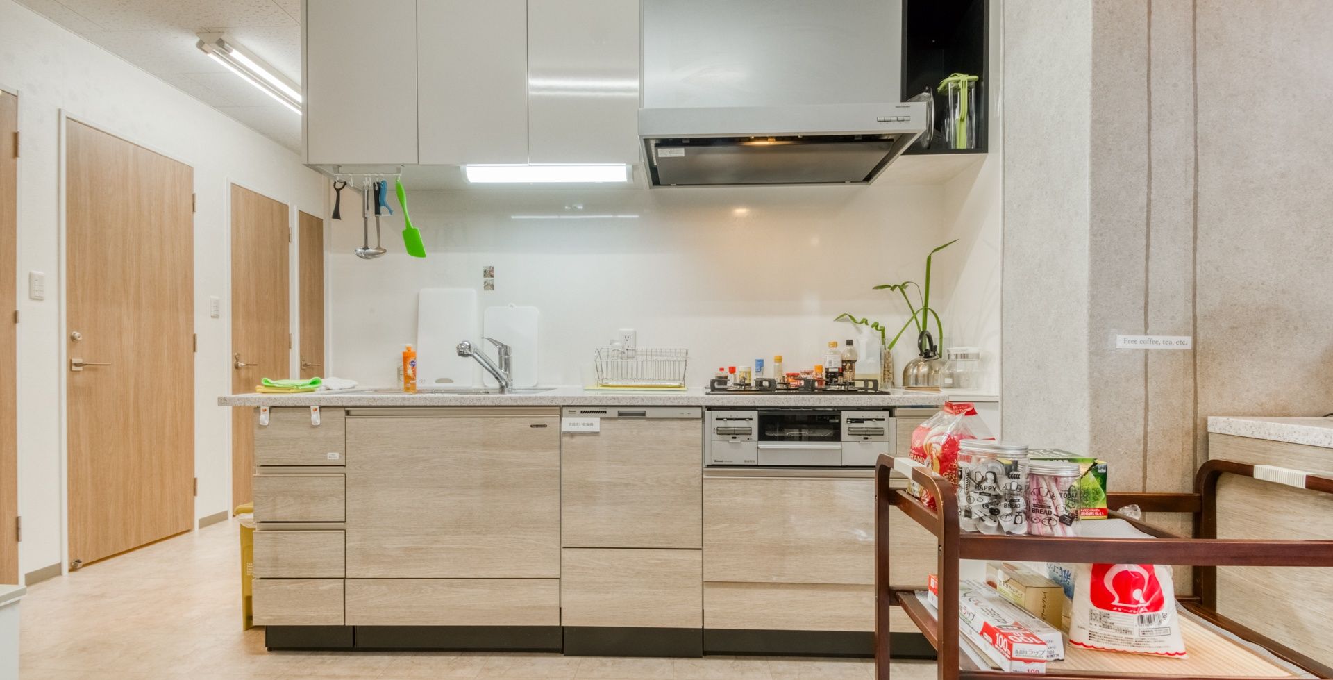 A modern kitchen with a central island, built-in appliances, and a dining area with a wooden table.