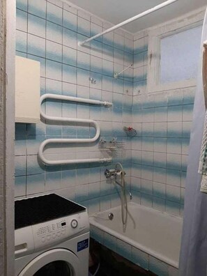 Combined shower/bathtub, towels, soap, toilet paper