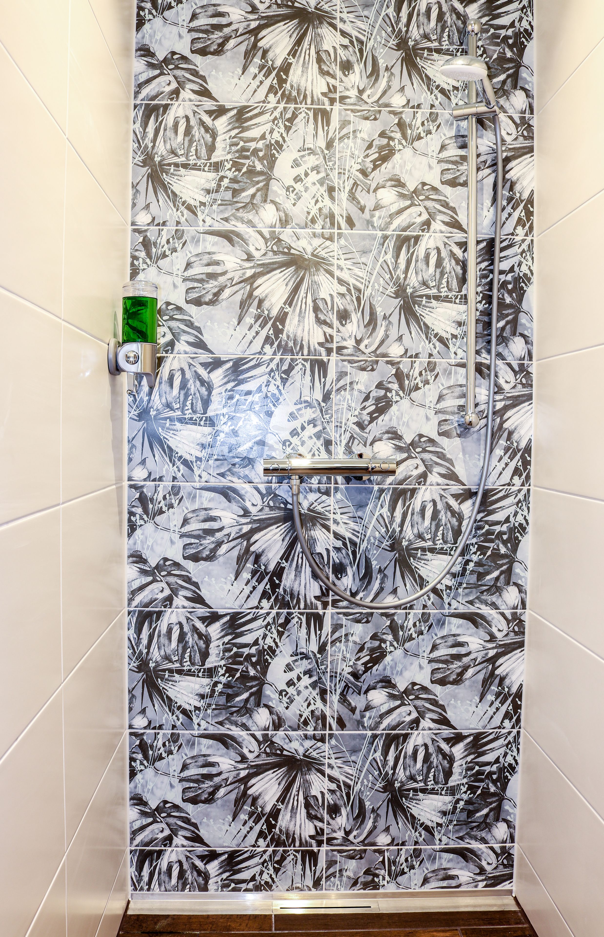 deluxe quadruple room | bathroom | shower, hair dryer, towels, soap